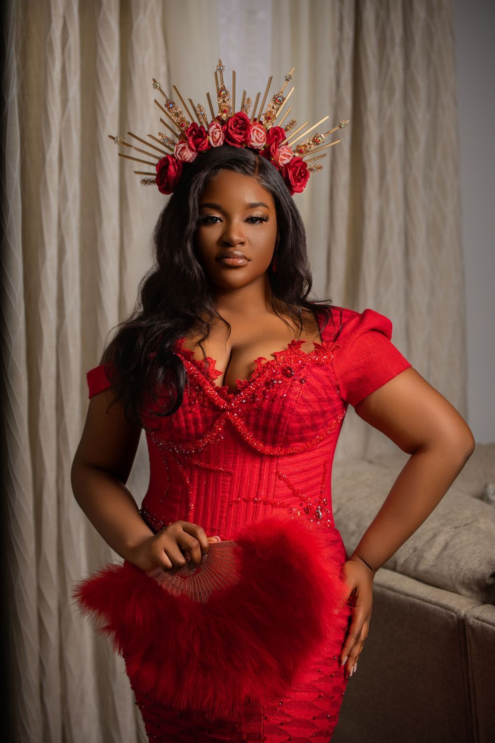 Glamorous portrait in red corseted dress with floral crown headpiece.