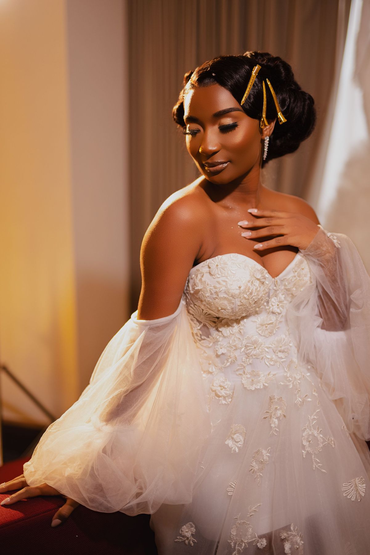 Elegant bridal portrait featuring detailed lace gown and ornate hair accessories.
